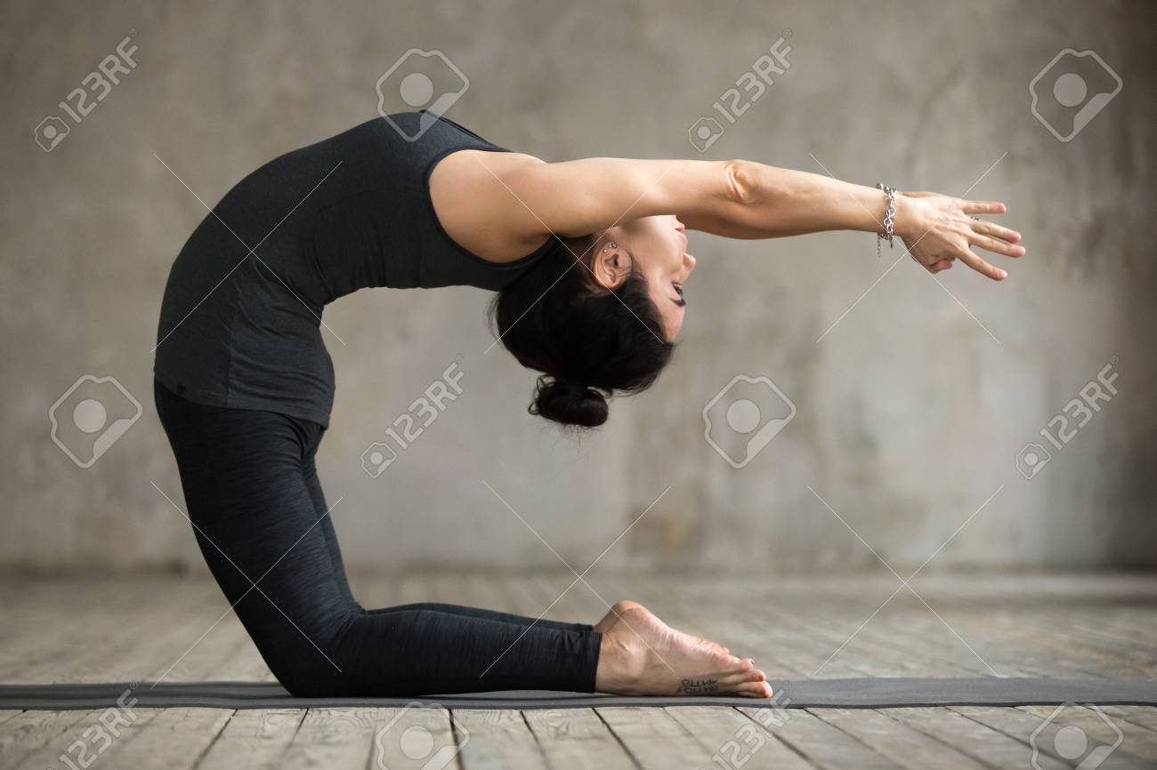 Young woman practicing yoga, doing Preparation for kapotasana,.. Young woman practicing yoga, doing Preparation for kapotasana,..