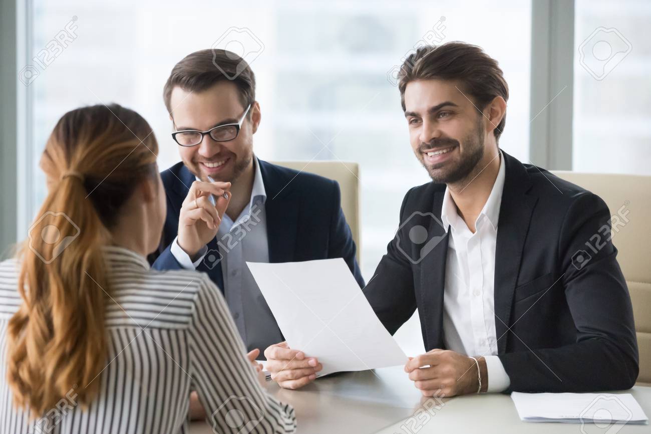 happy hr manager with resume in hands looking at female job seeker employer looking for resumes