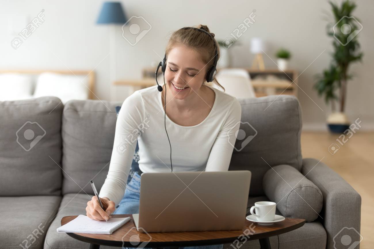 Happy girl interpreter in headset translate write notes listen audio course study work on laptop, smiling teen student wearing headphones learning online training class, distance education concept - 116535028 Happy girl interpreter in headset translate write notes listen audio course study work on laptop, smiling teen student wearing headphones learning online training class, distance education concept - 116535028
