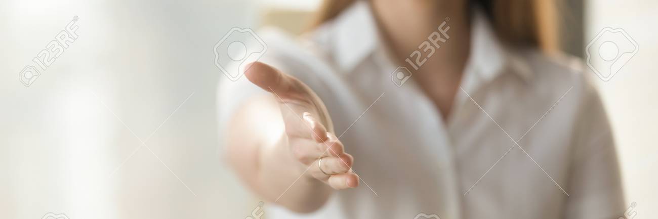 Businesswoman holds out her hand to camera for handshake, arm close up. Greeting negotiations first acquaintance hr concept. Horizontal photo banner for website header design with copy space for text - 117645377 Businesswoman holds out her hand to camera for handshake, arm close up. Greeting negotiations first acquaintance hr concept. Horizontal photo banner for website header design with copy space for text - 117645377