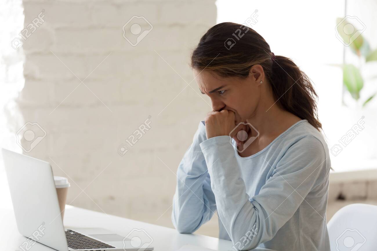 Worried Woman Frown Looking At Computer Screen. Millennial Female Facing  Business Problem. Confused Office Worker Getting Hard Task. Unhappy Student  Reading Email With Bad News. People At Work Concept Фотография, картинки,  изображения