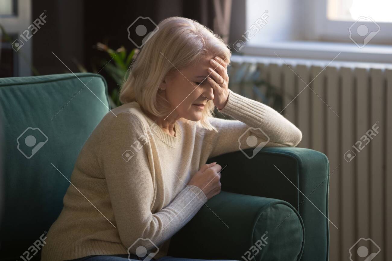https://previews.123rf.com/images/fizkes/fizkes1909/fizkes190900688/129610289-unwell-elderly-woman-sit-on-couch-touch-head-suffering-from-headache-or-migraine-hurt-unhealthy.jpg
