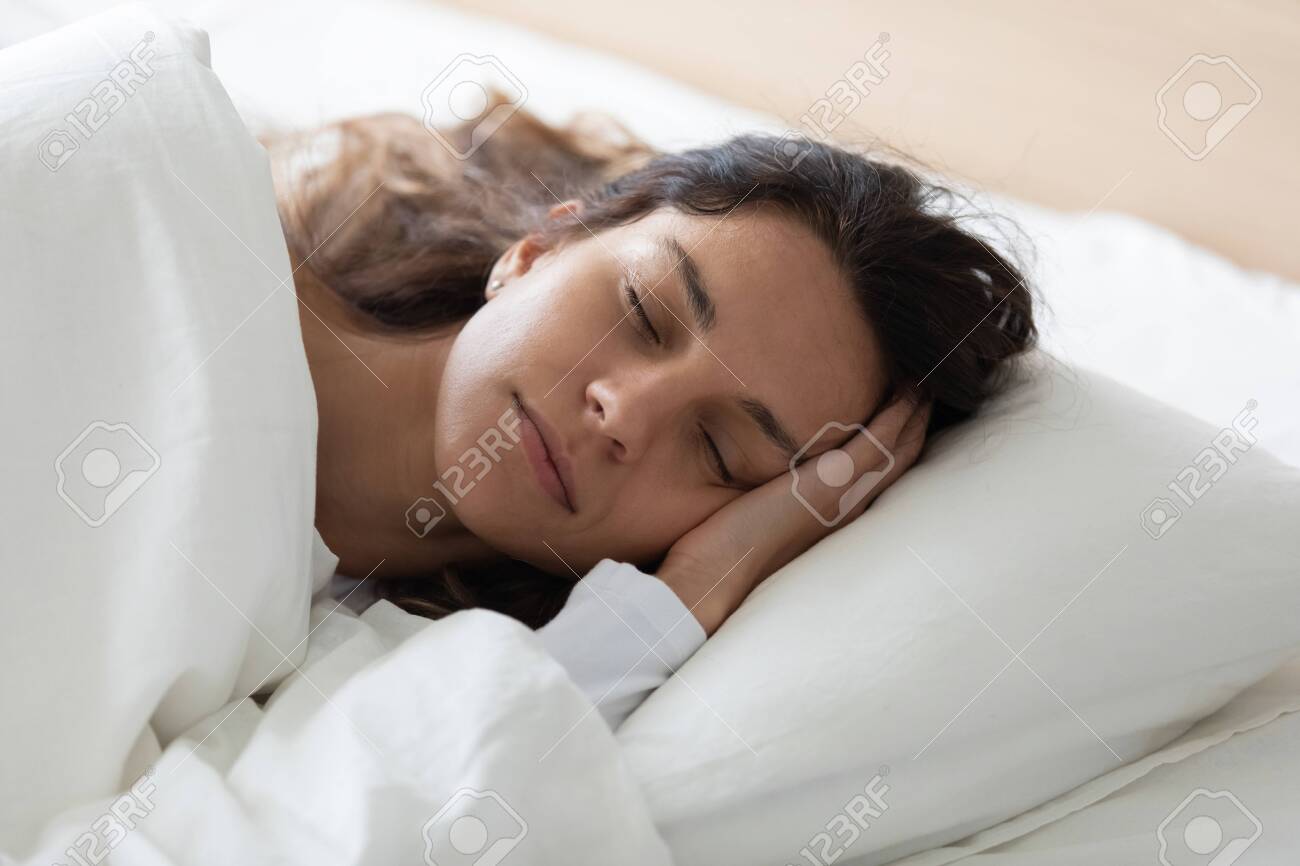 Head shot close up side view tranquil young biracial woman lying in bed, covered with fresh linen, enjoying lazy weekend time. Pretty girl relaxing with closed eyes, feeling peaceful at home. - 132120554 Head shot close up side view tranquil young biracial woman lying in bed, covered with fresh linen, enjoying lazy weekend time. Pretty girl relaxing with closed eyes, feeling peaceful at home. - 132120554