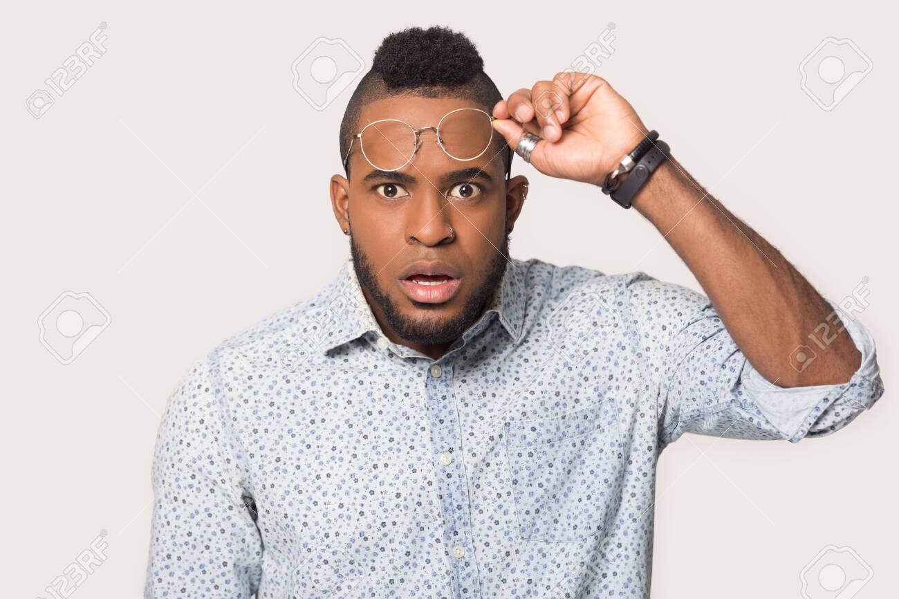 Headshot portrait of shocked african American man take off glasses look at camera stunned with deal or offer, amazed biracial male isolated on grey studio background feel surprised by unexpected news - 132349883 Headshot portrait of shocked african American man take off glasses look at camera stunned with deal or offer, amazed biracial male isolated on grey studio background feel surprised by unexpected news - 132349883