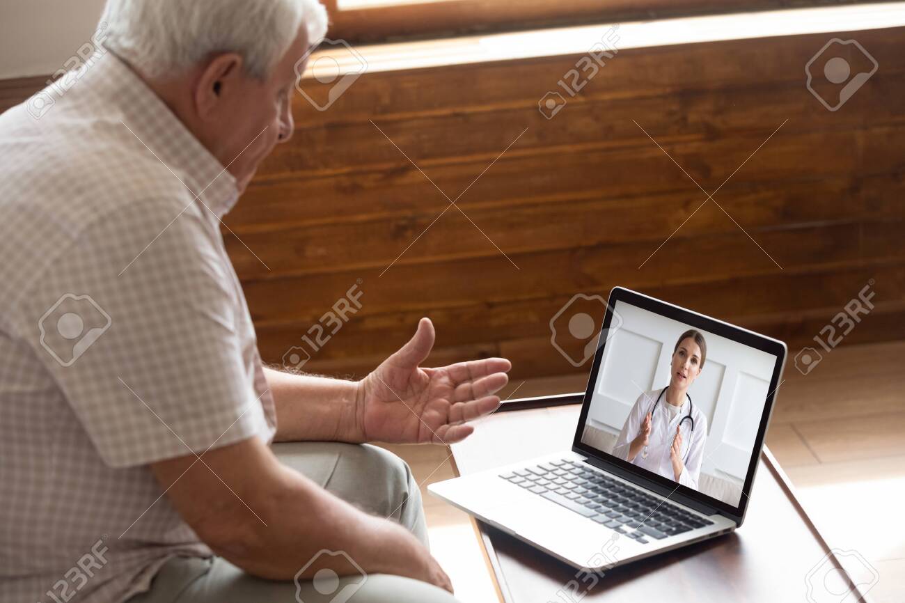 Focused older 80s male patient consulting with doctor via computer video call. Senior man looking at laptop screen, talking to therapist cardiologist online, older generation using modern technology. - 134207607 Focused older 80s male patient consulting with doctor via computer video call. Senior man looking at laptop screen, talking to therapist cardiologist online, older generation using modern technology. - 134207607