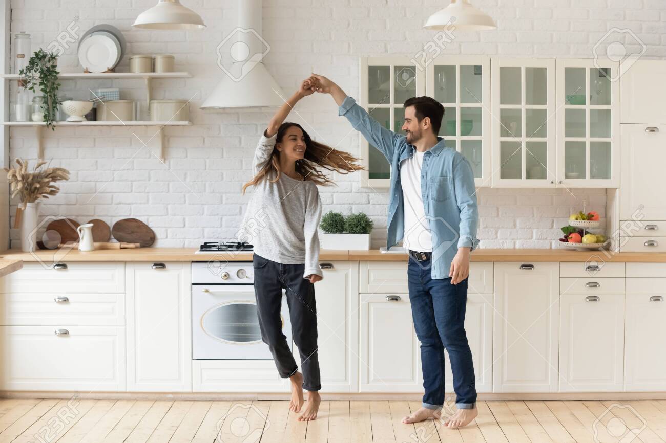 Happy Loving Couple Having Fun In Kitchen Dancing Together Stock Photo Picture And Royalty Free Image Image 142502434
