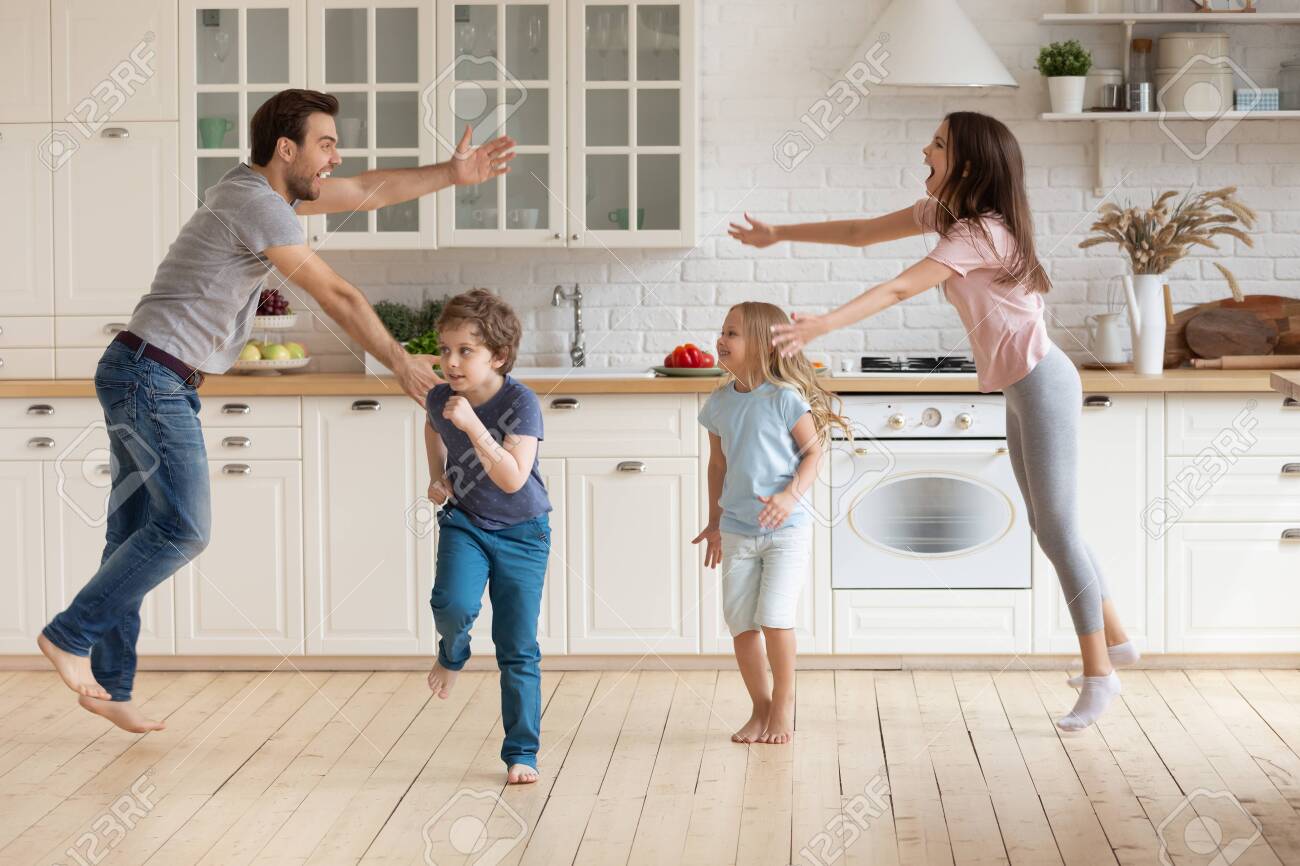 Overjoyed Young Family With Small Kids Entertain In Modern Spacious Stock Photo Picture And Royalty Free Image Image 142502628