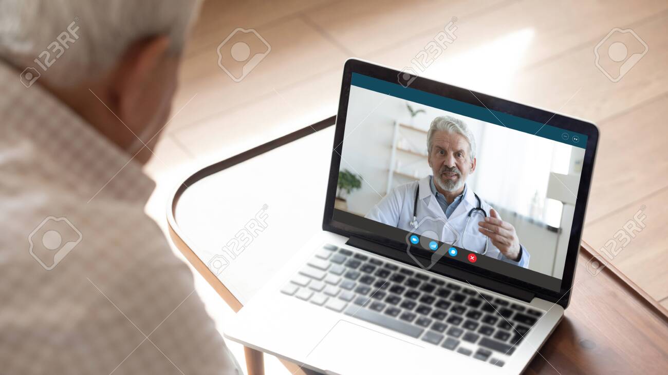 Back view of mature man have video call consultation with male doctor using laptop Webcam, close up of elderly male patient talk speak with GP or physician at home, discuss illness, consult online - 143600198 Back view of mature man have video call consultation with male doctor using laptop Webcam, close up of elderly male patient talk speak with GP or physician at home, discuss illness, consult online - 143600198