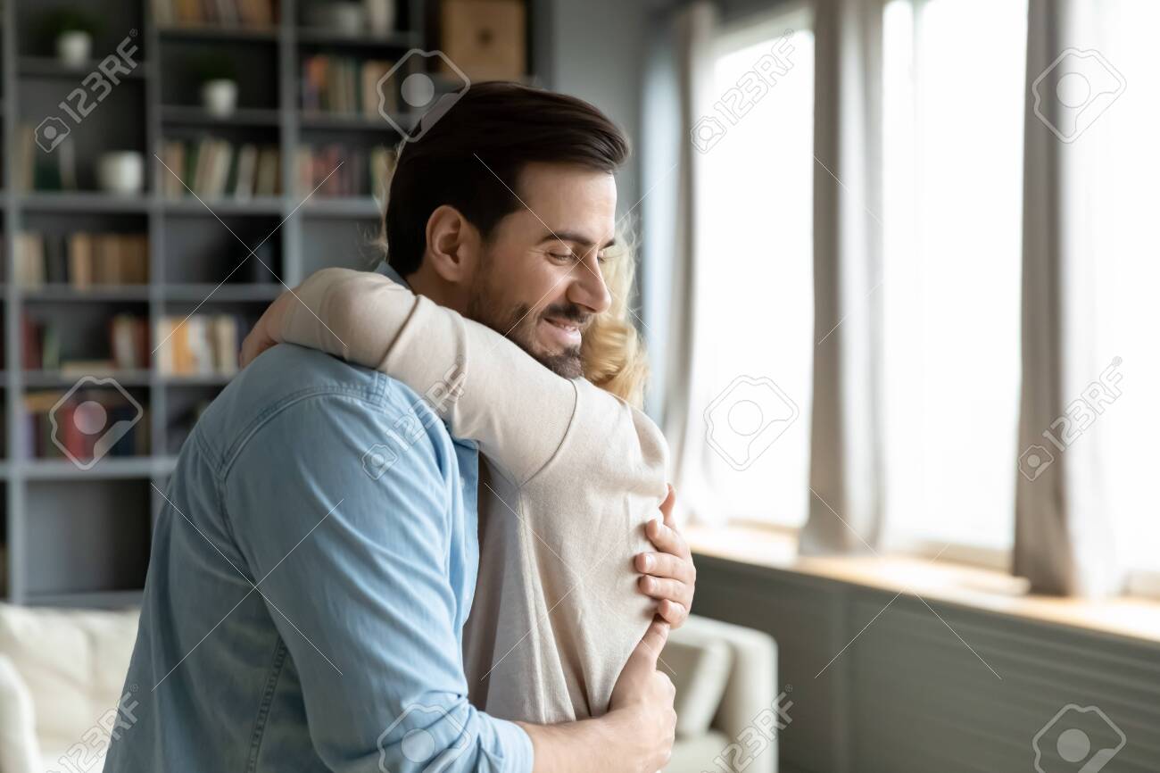 Caring Attentive Grown Up Son Visited Mother, Older Mom Hugs Adult  Millennial Child She Missed Him Enjoy Moment, Relatives People Standing  Inside Of Cozy Living Room Feels Happy, Family Bonds Concept Stock