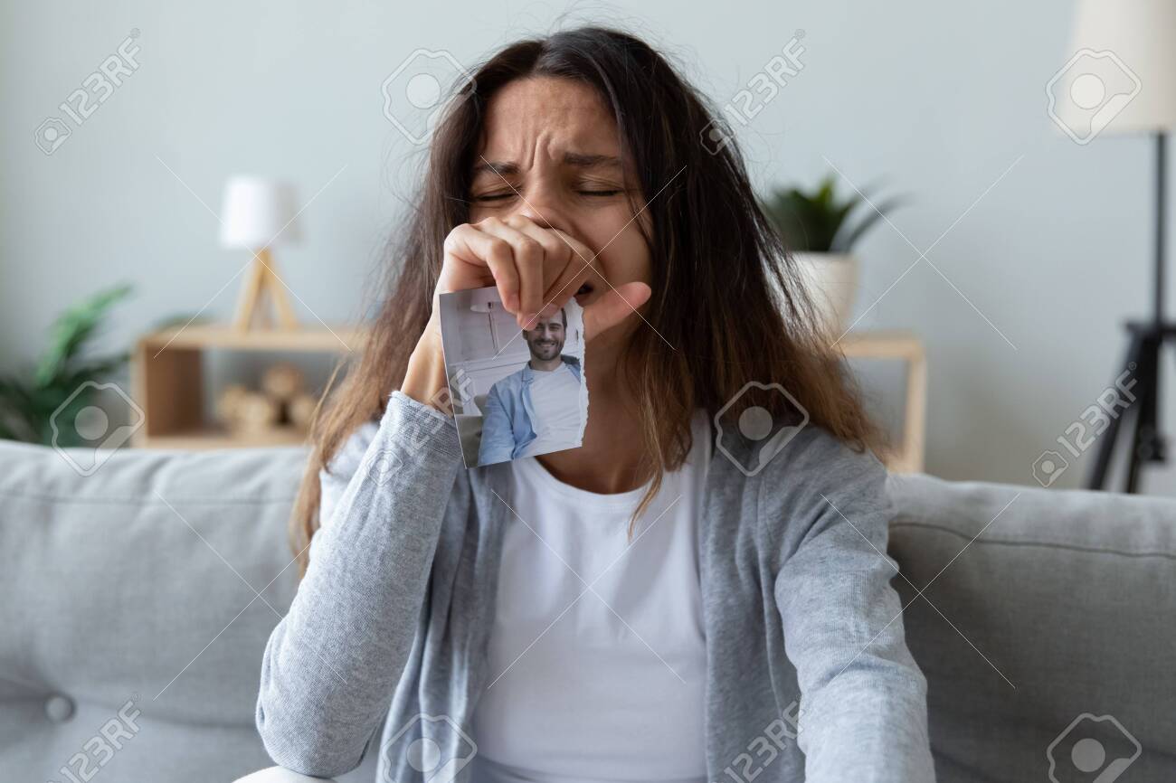 Depressed Young Woman Crying, Holding photo