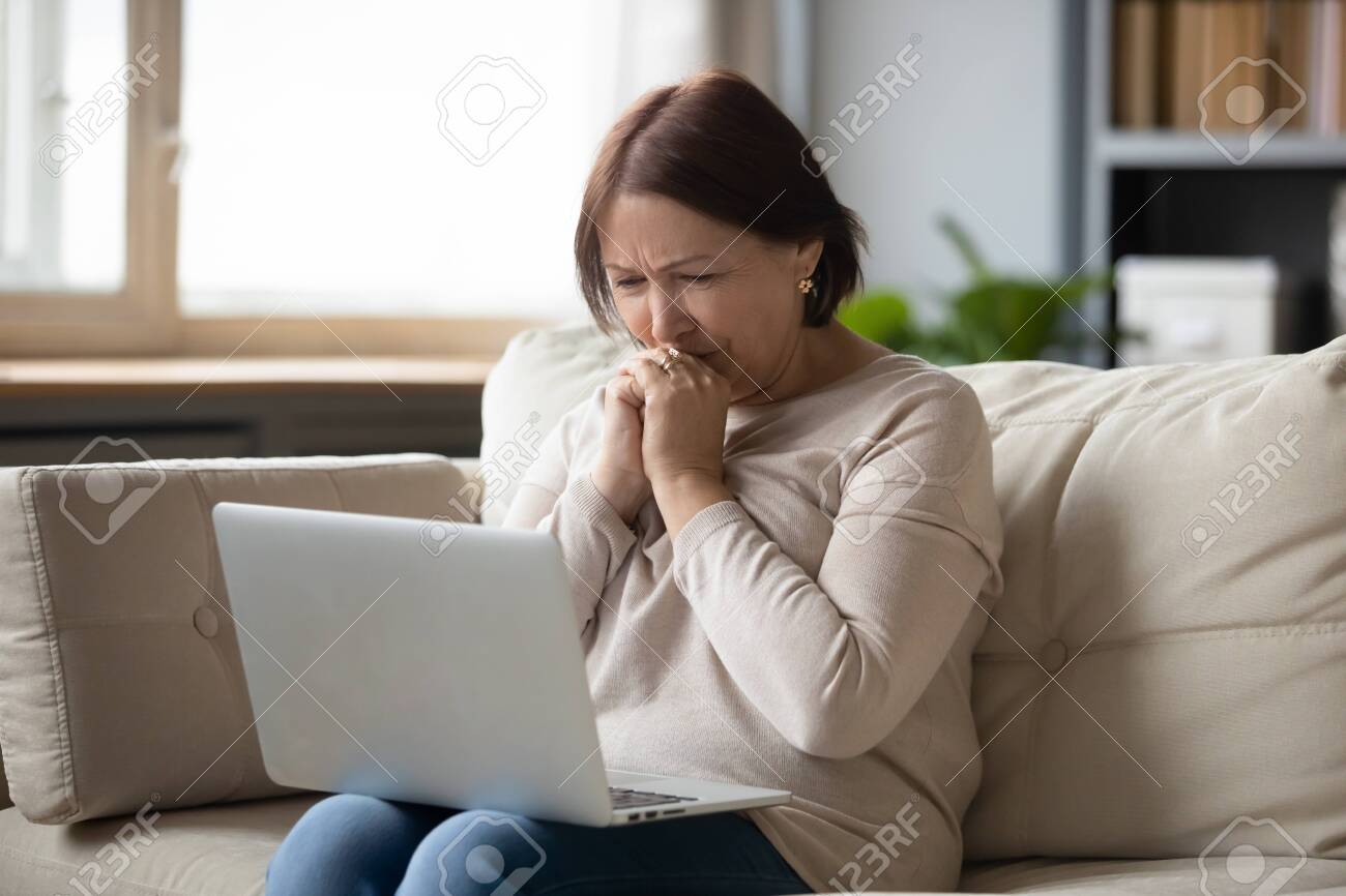 Sad Mature Woman Looking At Laptop pic