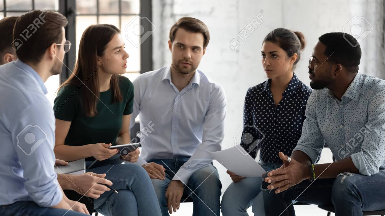 Young Professionals Company Employees Diverse Staff Members Gather Together  Sit On Chairs Brainstorming Solving Working Moments Having Dispute Express  Opinion Point Of View. Teamwork Briefing Activity Stock Photo, Picture and  Royalty Free, image size:1300x731