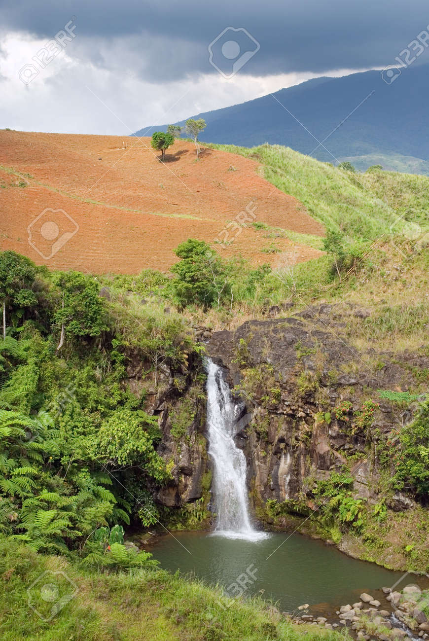 Tropical Wild Landscape On The Bukidnon (Mindanao, Philippines) Volcanic  Mountainous Plateau With Red Fertile Volcanic Soil, Jungle, Canyons And A  Secluded Waterfall. Stock Photo, Picture and Royalty Free Image. Image  5459268., image size:870x1300