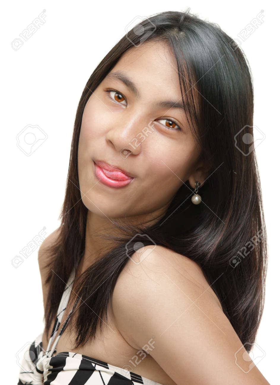 Closeup Portrait Of Sex Asian Girl Licking Lips With Tongue In An Alluring And Defiant Wait. Isolated Over White