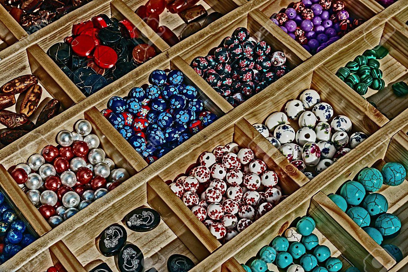 Colored beads with different shapes, presented in a wooden box divided - 17543966 Colored beads with different shapes, presented in a wooden box divided - 17543966