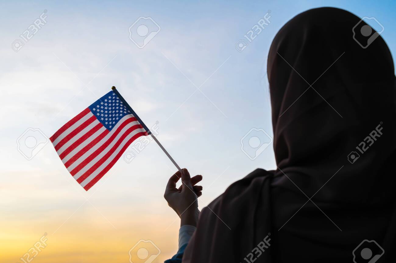 Silhouette Of Muslim Woman In Scarf With American, Flag Of At Sunset.  America. Concept Фотография, картинки, изображения и сток-фотография без  роялти. Image 144129421