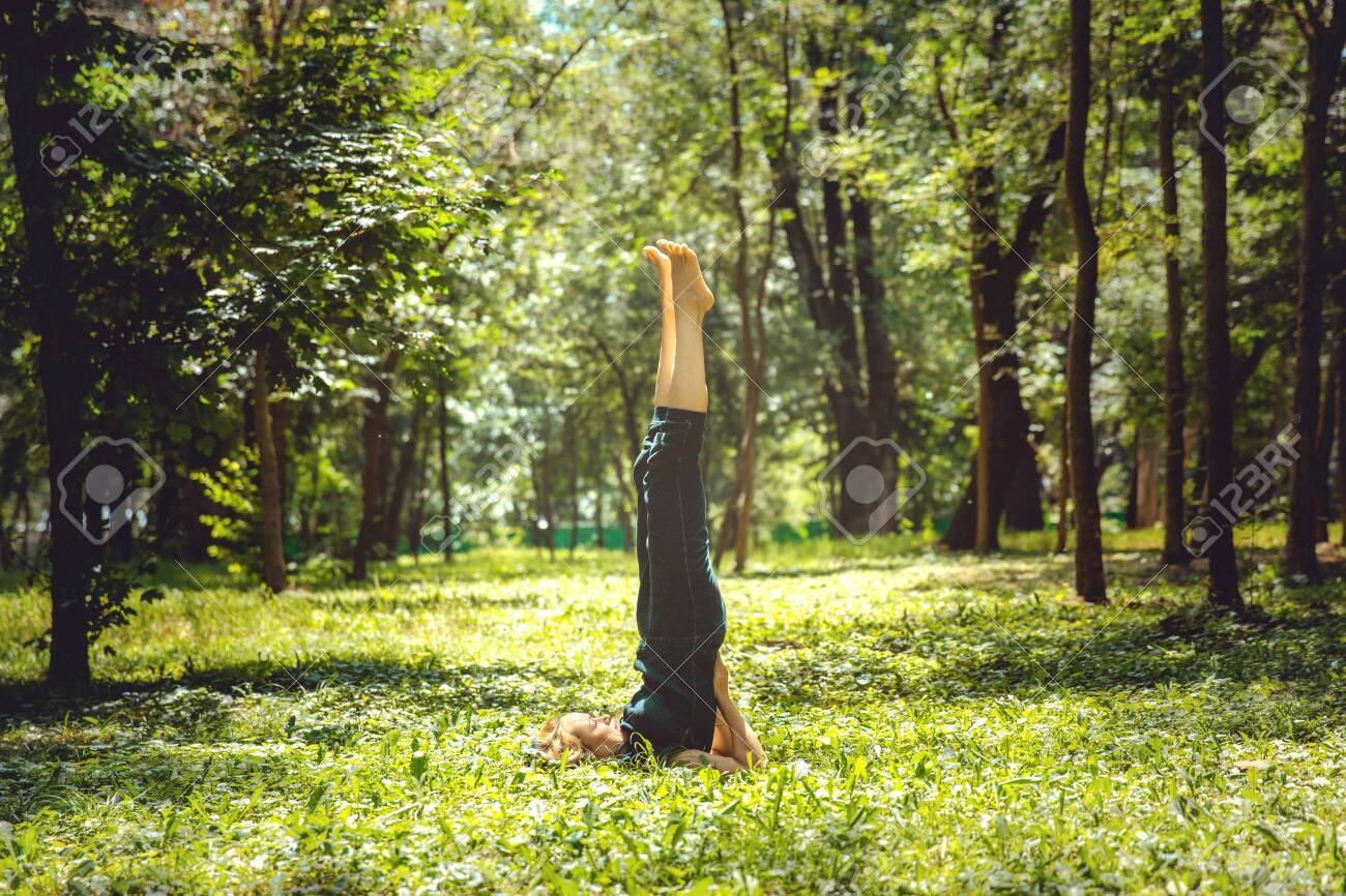 Salamba Sarvangasana. Yoga asanas in nature. Yoga poses everyday Salamba Sarvangasana. Yoga asanas in nature. Yoga poses everyday
