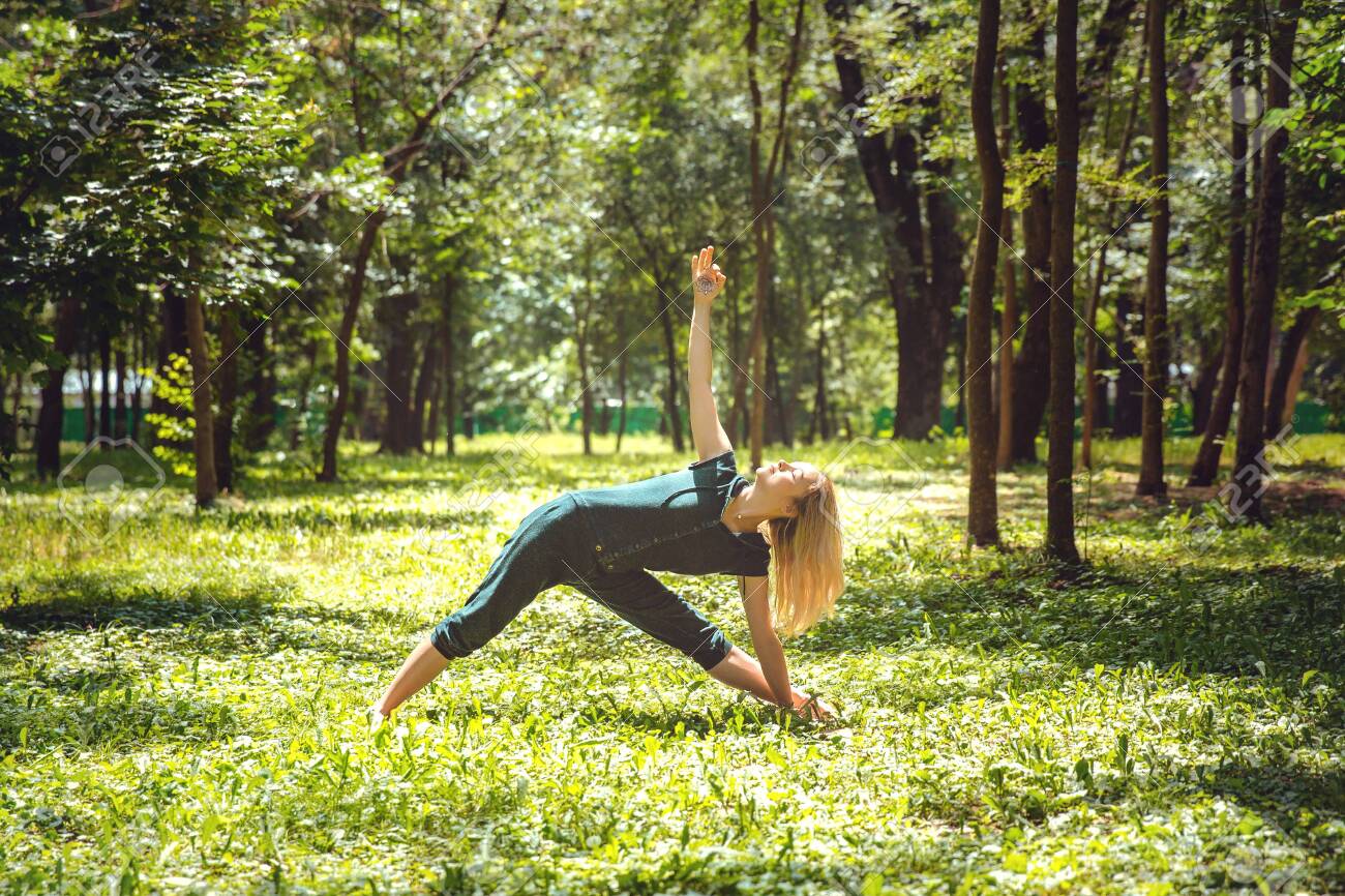 Utthita trikonasana. Yoga asanas in nature. Yoga poses everyday Utthita trikonasana. Yoga asanas in nature. Yoga poses everyday