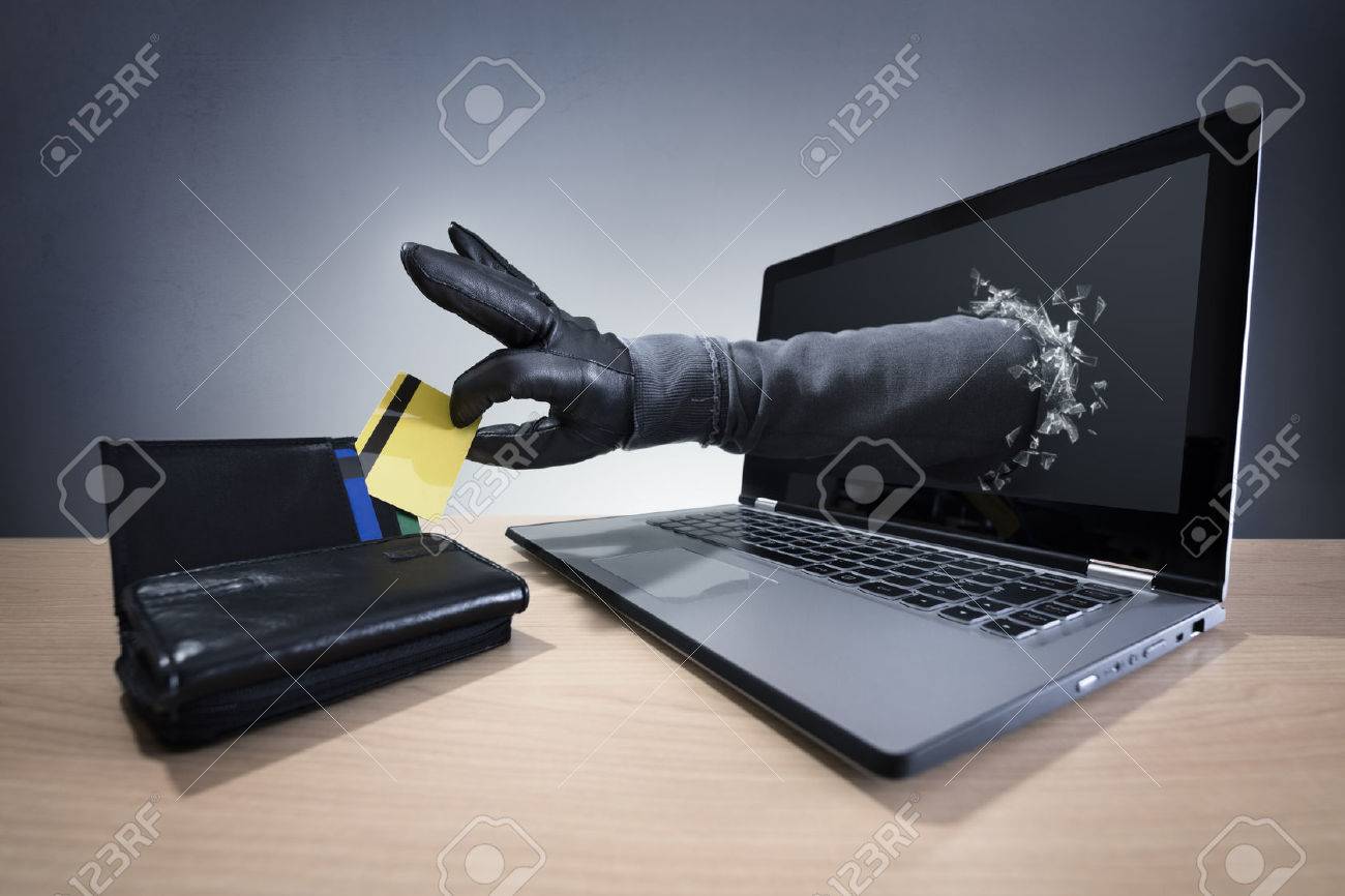 Stealing a credit card through a laptop concept for computer hacker, network security and electronic banking security - 45840475 Stealing a credit card through a laptop concept for computer hacker, network security and electronic banking security - 45840475