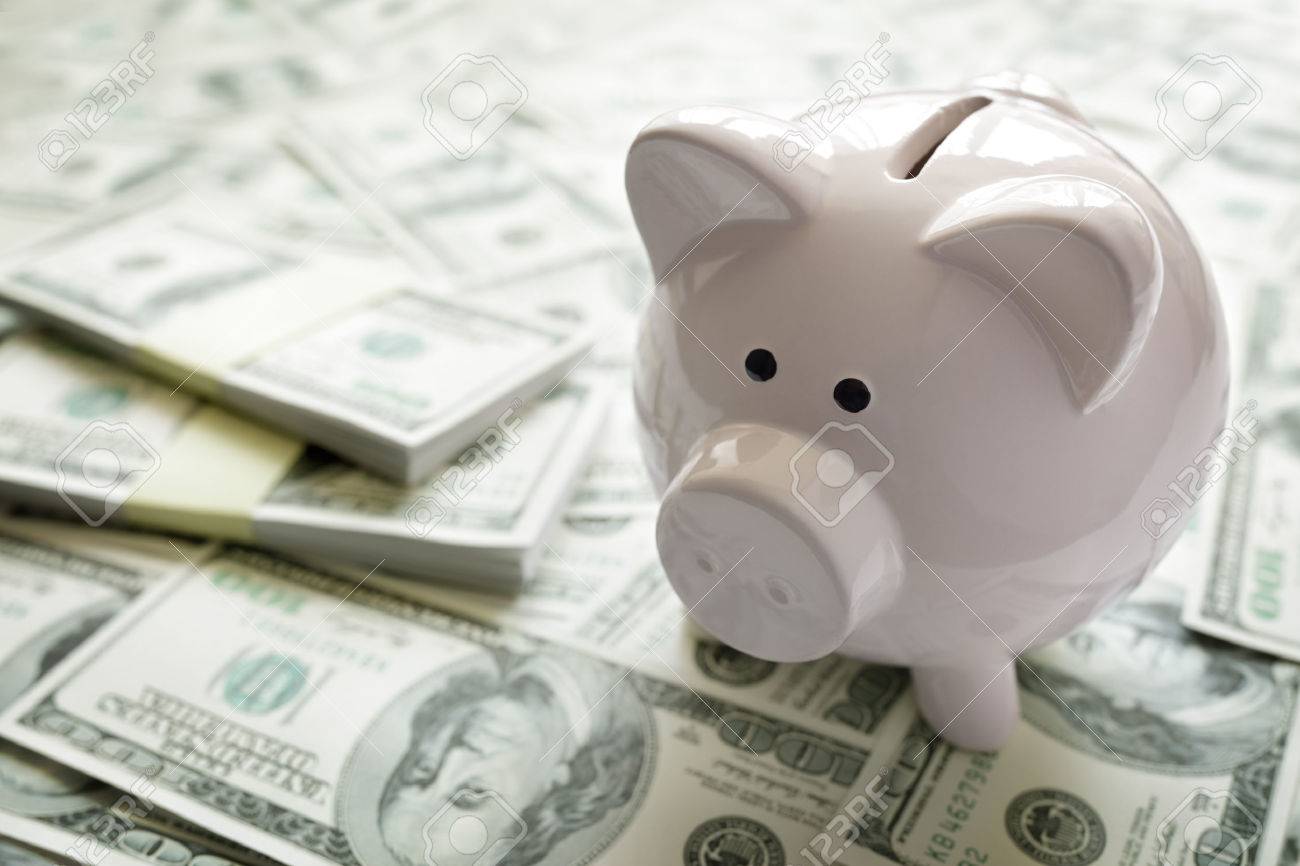 Piggy bank on money concept for business finance, investment, saving or retirement fund - 54428256 Piggy bank on money concept for business finance, investment, saving or retirement fund - 54428256