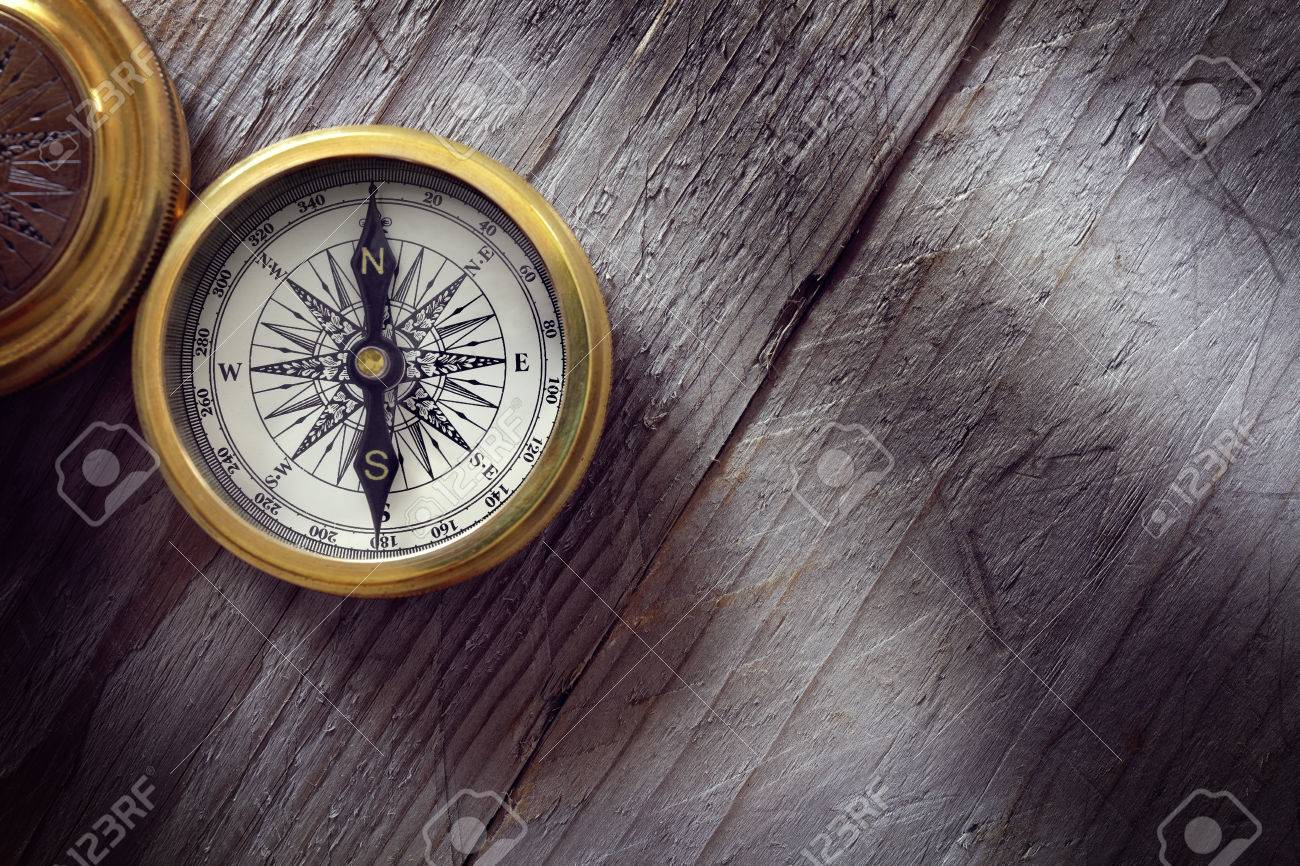 Antique golden compass on wood background concept for direction, travel, guidance or assistance - 54428265 Antique golden compass on wood background concept for direction, travel, guidance or assistance - 54428265