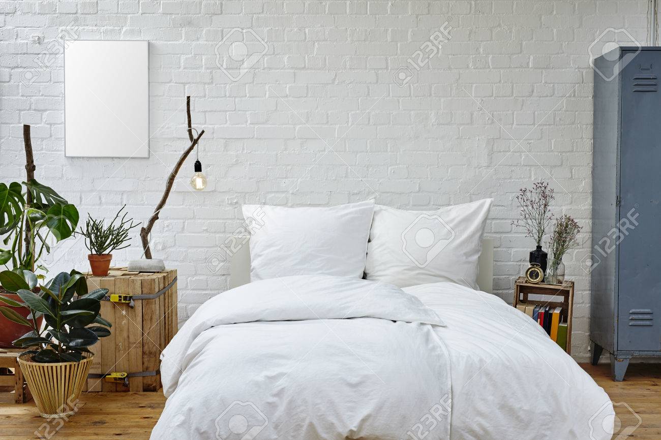 Vintage Urban Bedroom White Bedspread Green Plants And Warm Colors