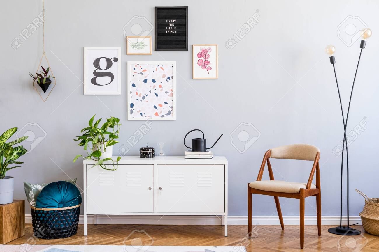 Stylish home interior of living room with mock up posters gallery wall, white shelf, design armchair, plants, flowers, lamp and elegant accessories. Gray background walls. Scandi home decor. Template. - 134013852 Stylish home interior of living room with mock up posters gallery wall, white shelf, design armchair, plants, flowers, lamp and elegant accessories. Gray background walls. Scandi home decor. Template. - 134013852