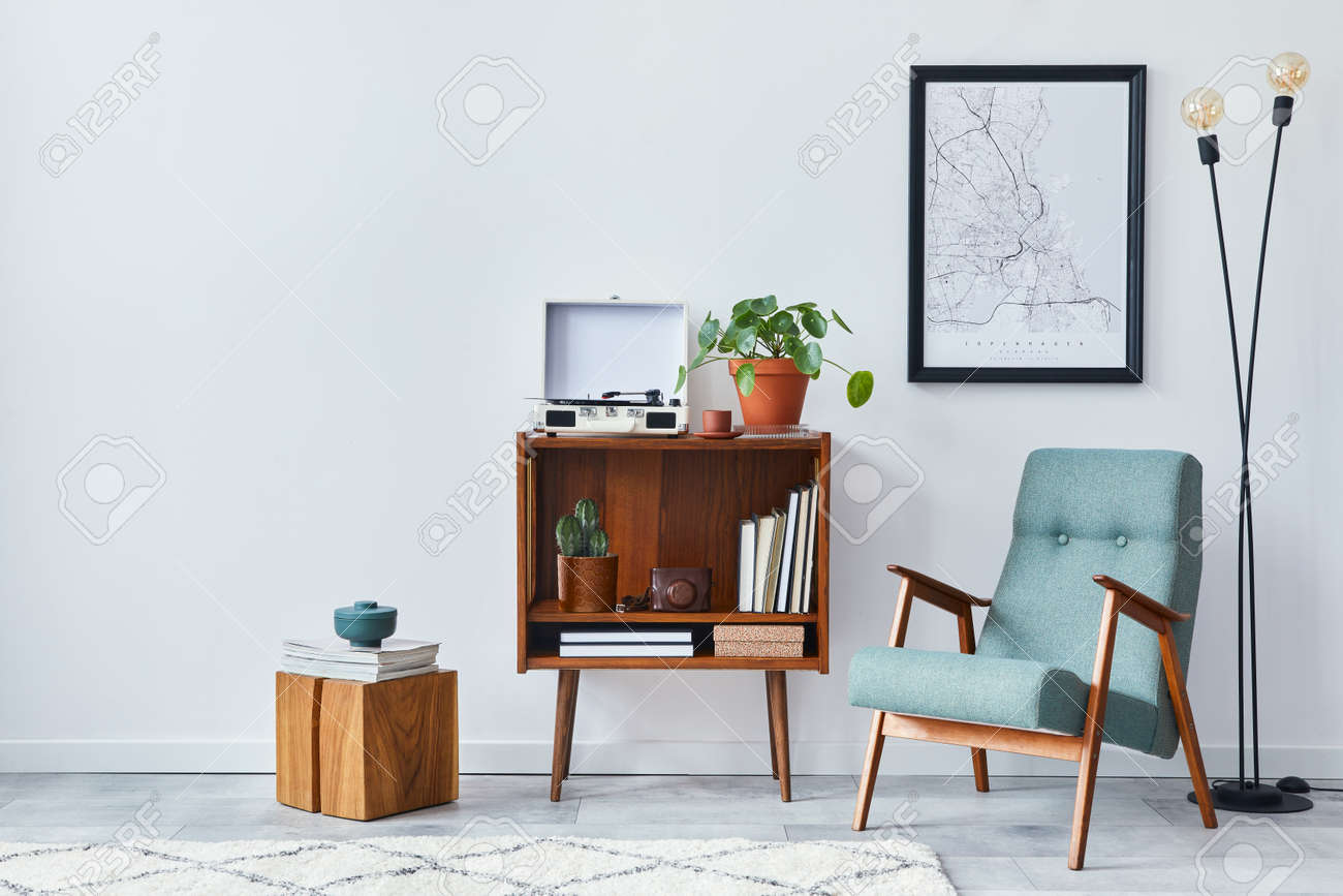 Modern retro composition of living room interior with design wooden cabinet, stylish armchair, mock up poster map, plants, vinyl recorder, books and personal accessories in home decor. Template. - 168356132 Modern retro composition of living room interior with design wooden cabinet, stylish armchair, mock up poster map, plants, vinyl recorder, books and personal accessories in home decor. Template. - 168356132