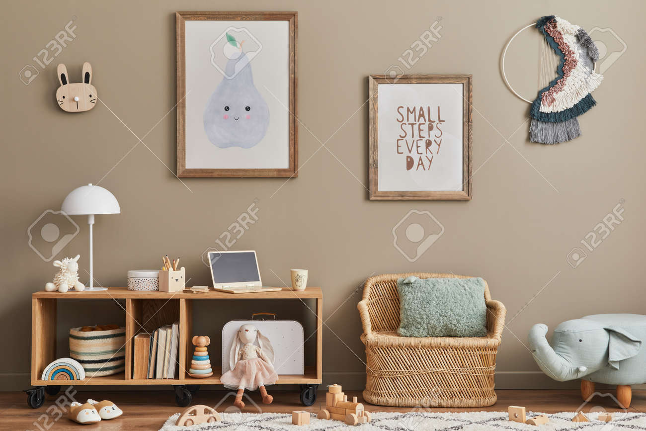Cozy interior of child room with mint armchair, brown mock up poster frame, toys, teddy bear, plush animal, decoration and hanging cotton colorful balls. Beige wall. Warm kid space. Template. - 168356610 Cozy interior of child room with mint armchair, brown mock up poster frame, toys, teddy bear, plush animal, decoration and hanging cotton colorful balls. Beige wall. Warm kid space. Template. - 168356610