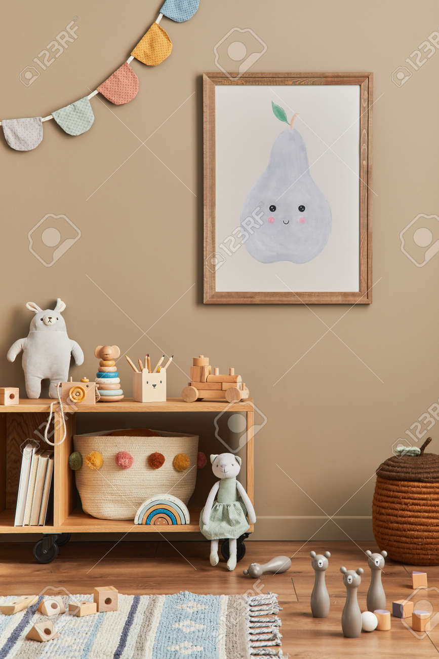 Stylish scandinavian newborn baby room with brown wooden mock up poster frame, toys, plush animal and child accessories. Cozy decoration and hanging cotton flags on the beige wall. Template. - 168356614 Stylish scandinavian newborn baby room with brown wooden mock up poster frame, toys, plush animal and child accessories. Cozy decoration and hanging cotton flags on the beige wall. Template. - 168356614