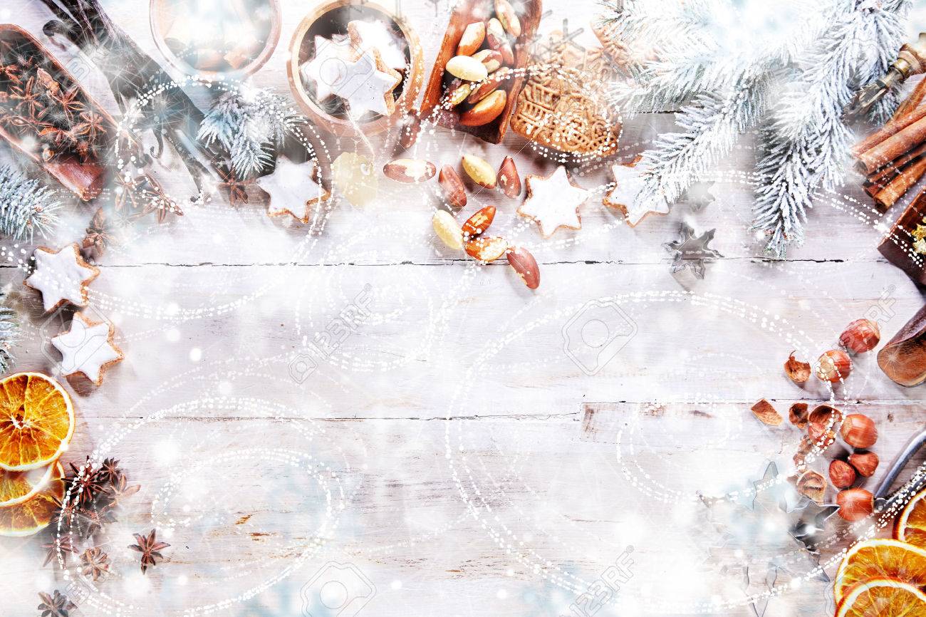 white christmas background with empty copy space cakes and nuts
