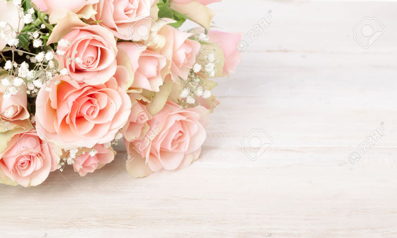 Delicate bouquet of fresh pink roses on a textured white wood background with copy space for your Valentines, Mothers Day, anniversary or birthday wishes - 52284715 Delicate bouquet of fresh pink roses on a textured white wood background with copy space for your Valentines, Mothers Day, anniversary or birthday wishes - 52284715