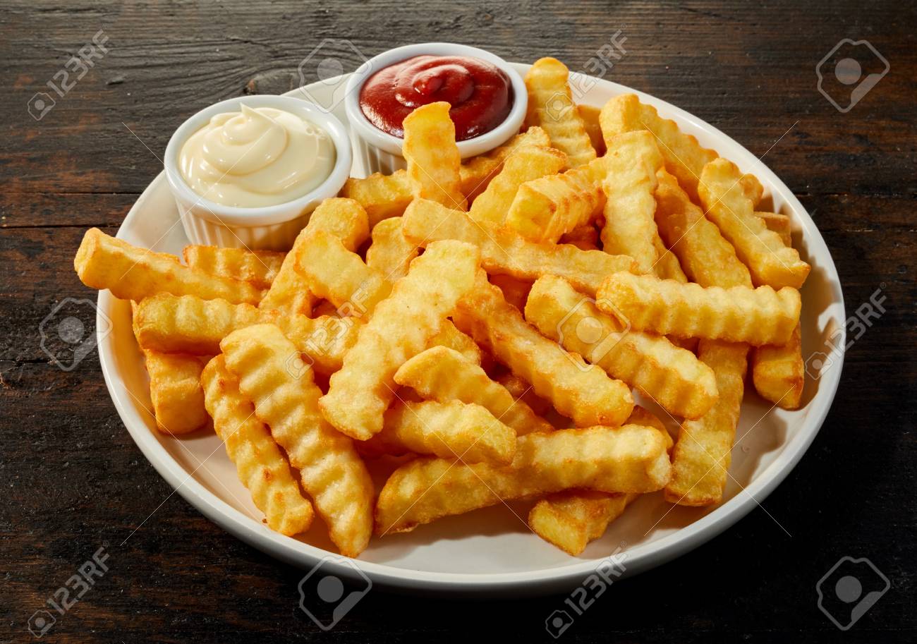 Plate Of Crinkle Cut Crisp Golden French Fries With Mustard Stock Photo Picture And Royalty Free Image Image 116593315