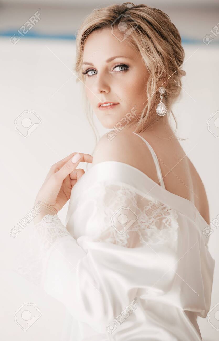 Beautiful blonde bride with stylish make-up in white dress - 130994538 Beautiful blonde bride with stylish make-up in white dress - 130994538