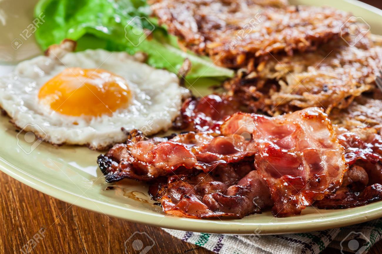 hash browns potato pancakes with crispy fried bacon and fried