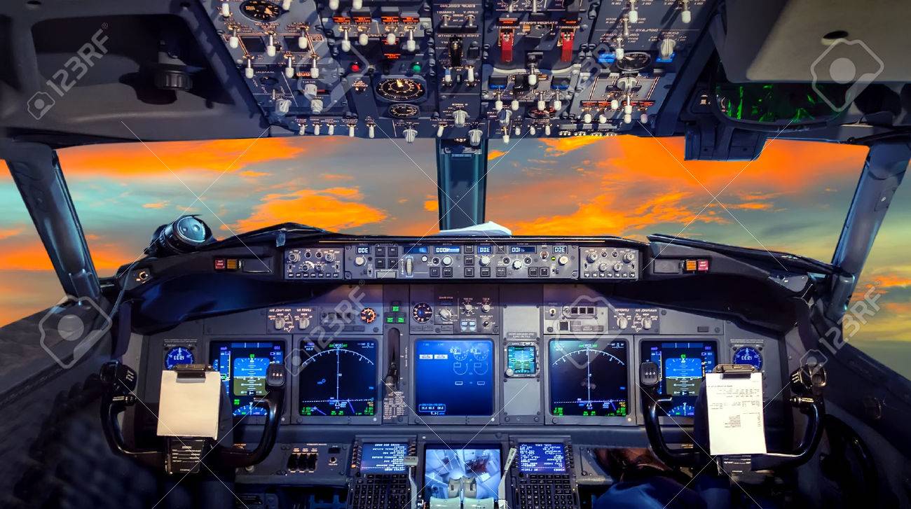 airplane cockpit flight deck in sunset stock photo picture and