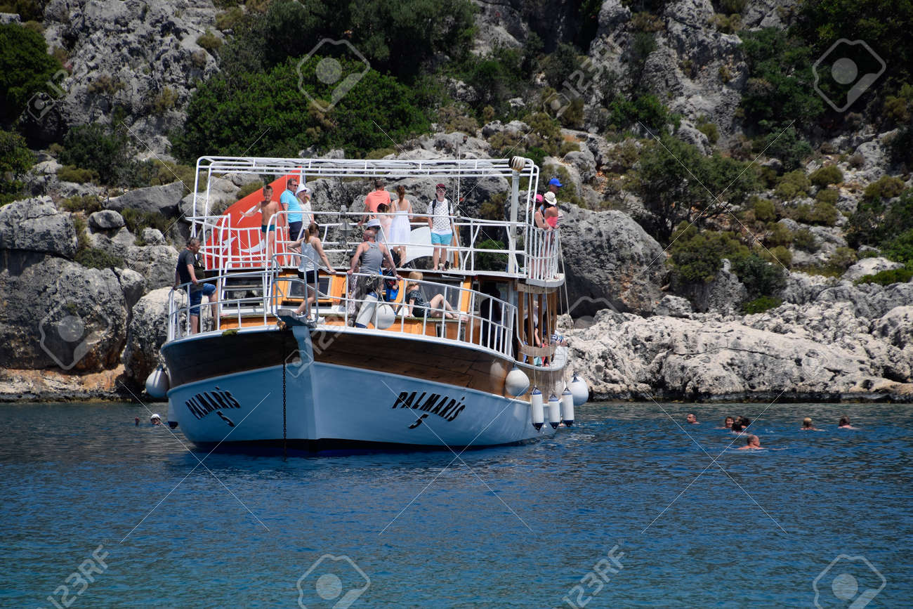 Demre, Turkey - May 21, 2019: Tourists swim in the sea near a pleasure yacht. The Mediterranean Sea off the coast of Kekova and Demre. Many vacationers are swimming in the Mediterranean Sea near the cruise boat. - 133522566 Demre, Turkey - May 21, 2019: Tourists swim in the sea near a pleasure yacht. The Mediterranean Sea off the coast of Kekova and Demre. Many vacationers are swimming in the Mediterranean Sea near the cruise boat. - 133522566