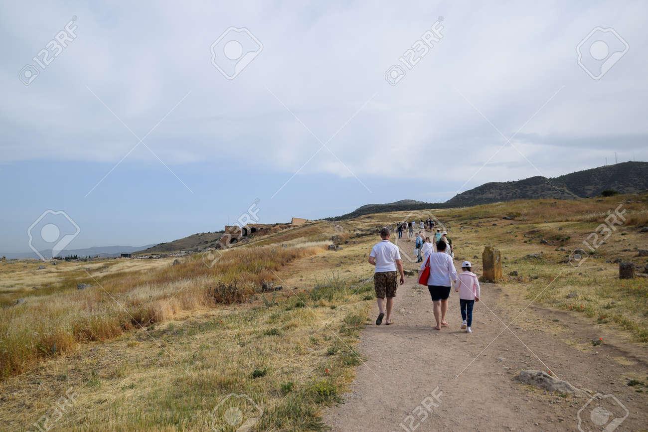 Pamukkale, Hierapolis, Turkey - May 22, 2019: Tour groups on the ruins of Hierapolis. Tourists are shown the ruins of the ancient city. - 133523210 Pamukkale, Hierapolis, Turkey - May 22, 2019: Tour groups on the ruins of Hierapolis. Tourists are shown the ruins of the ancient city. - 133523210