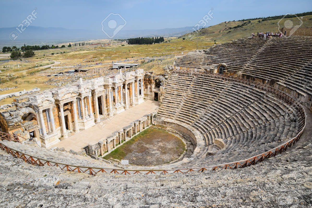 Pamukkale, Hierapolis, Turkey - May 22, 2019: Ancient antique amphitheater in the city of Hierapolis in Turkey. Steps and antique statues with columns in the amphitheater - 133523214 Pamukkale, Hierapolis, Turkey - May 22, 2019: Ancient antique amphitheater in the city of Hierapolis in Turkey. Steps and antique statues with columns in the amphitheater - 133523214