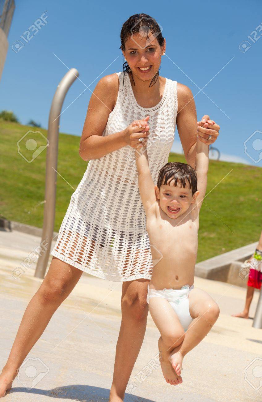 Pretty Young Hispanic Mother With Her Baby Boy Having Fun At A Park Stock  Photo, Picture and Royalty Free Image. Image 10255172., image size:848x1300