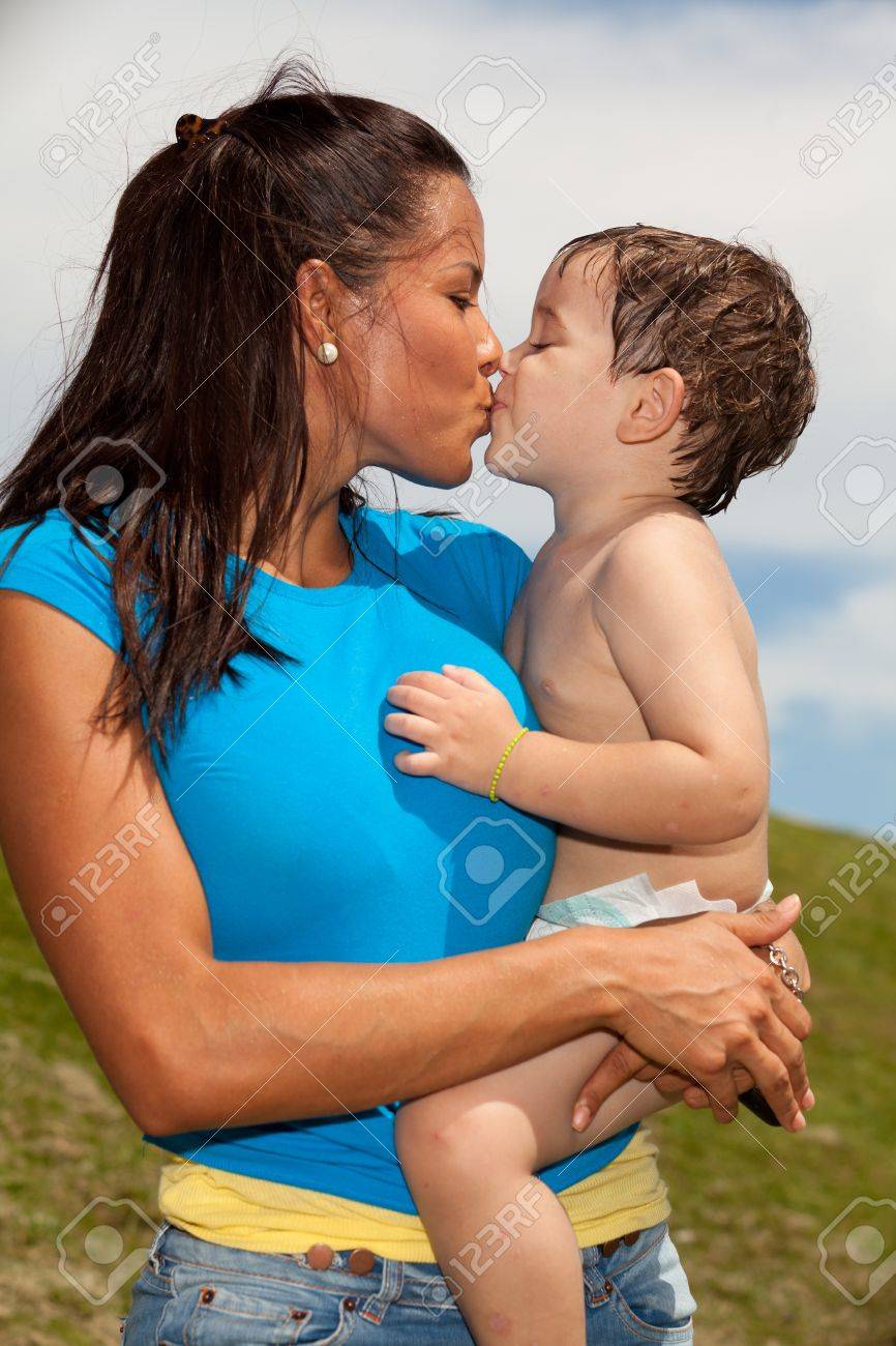 Pretty Young Hispanic Woman Kissing A Cute Baby Boy In A Park Setting Stock  Photo, Picture and Royalty Free Image. Image 10255187., image size:866x1300