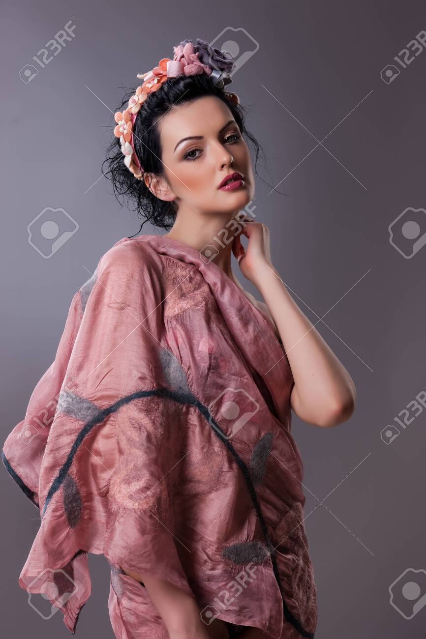 Young beautiful brunette woman in handmade fashionable clothing - 128432154 Young beautiful brunette woman in handmade fashionable clothing - 128432154