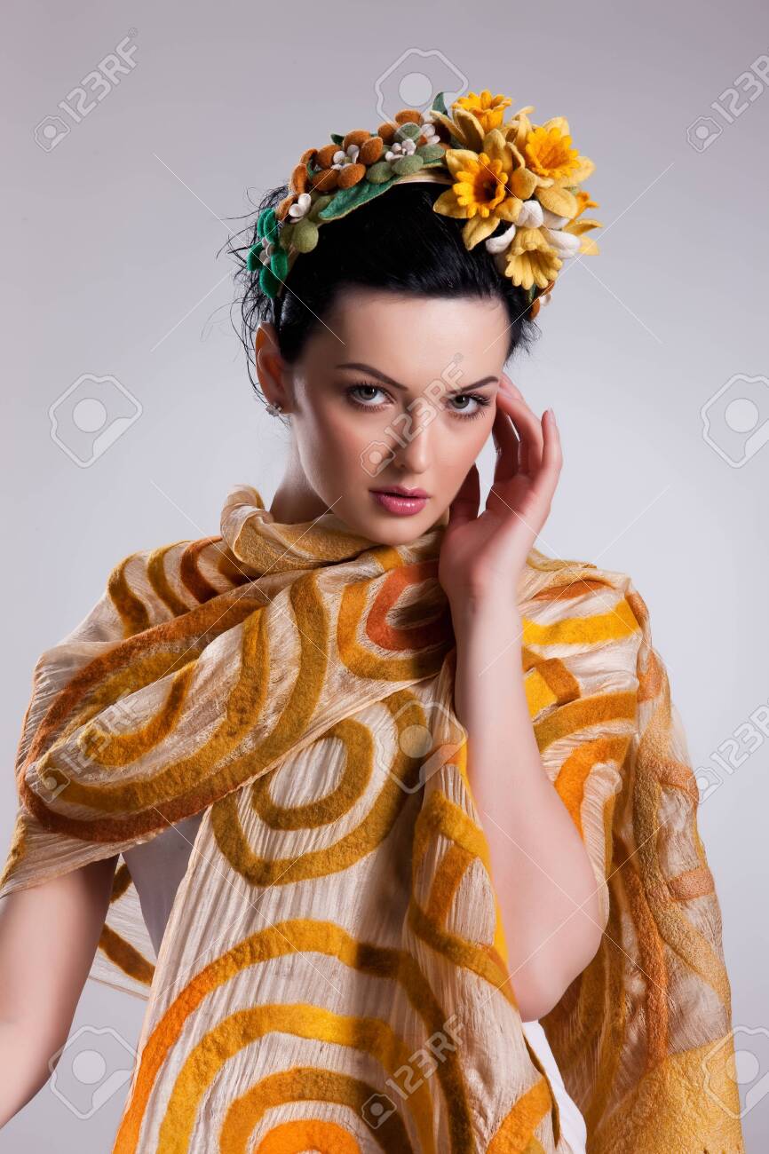 Young attractive woman dressed in fashionable handmade clothing on isolated background - 128432243 Young attractive woman dressed in fashionable handmade clothing on isolated background - 128432243