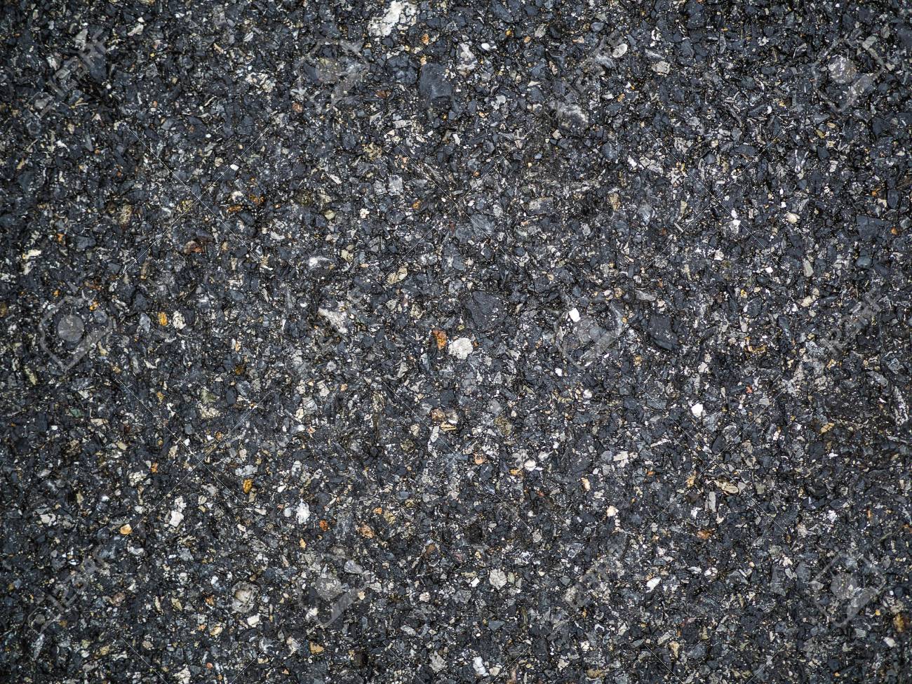 The texture of the background of stone black gray asphalt road