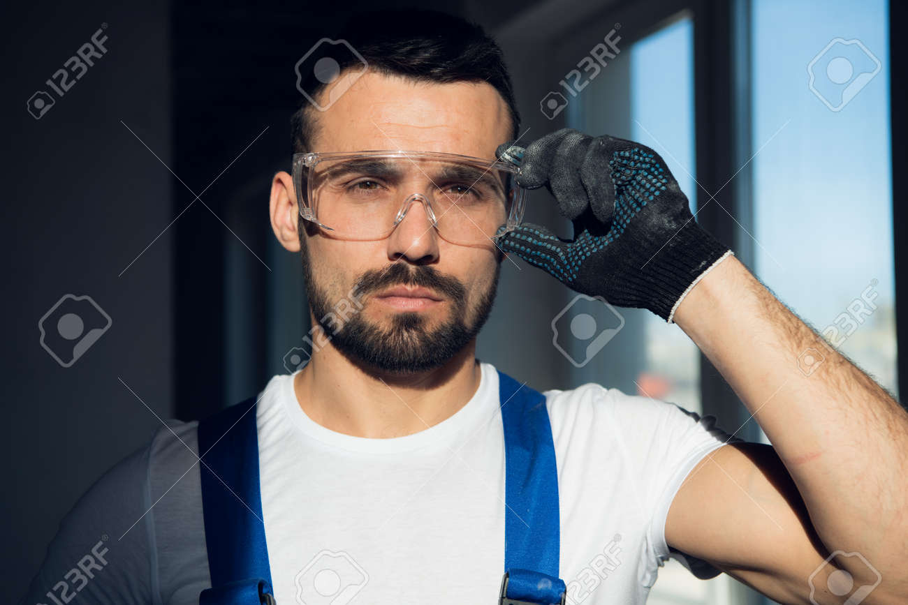 Close up, bearded craftsman wearing protective glasses - 170308388 Close up, bearded craftsman wearing protective glasses - 170308388