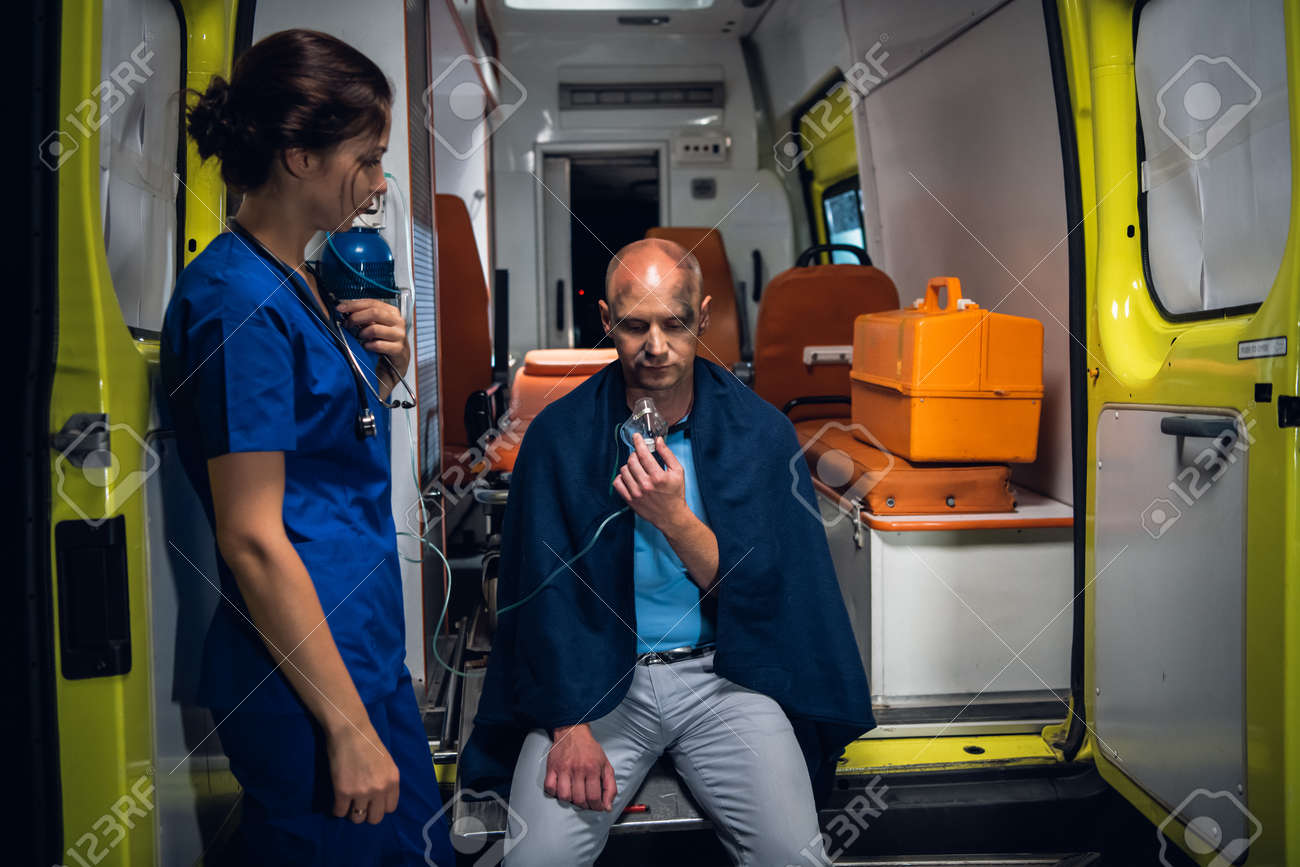 An EMT taking care of a man rescued from the fire - 170400999 An EMT taking care of a man rescued from the fire - 170400999