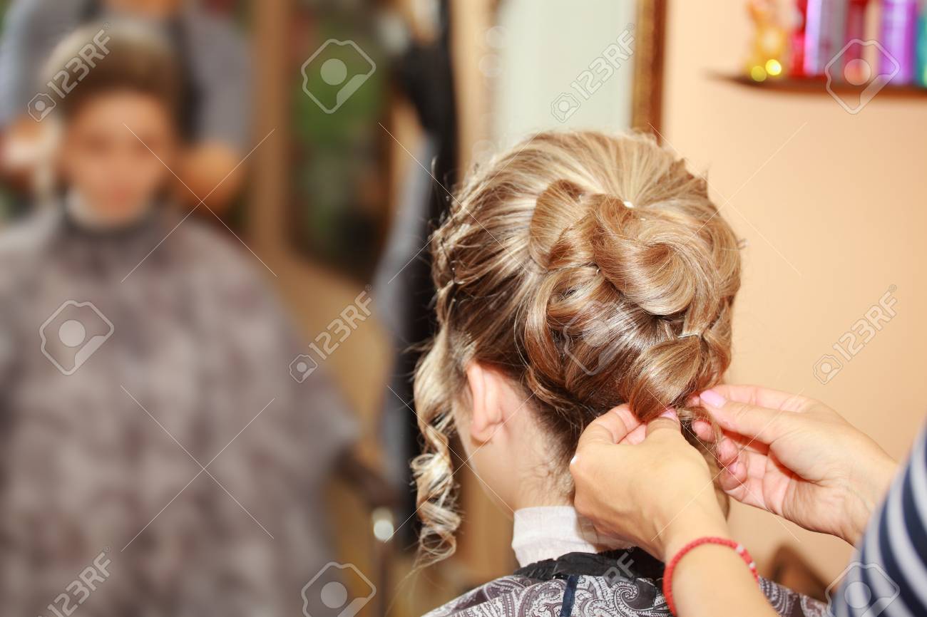 A Young Girl On The Wedding Day Makes A Beautiful Hairstyle At