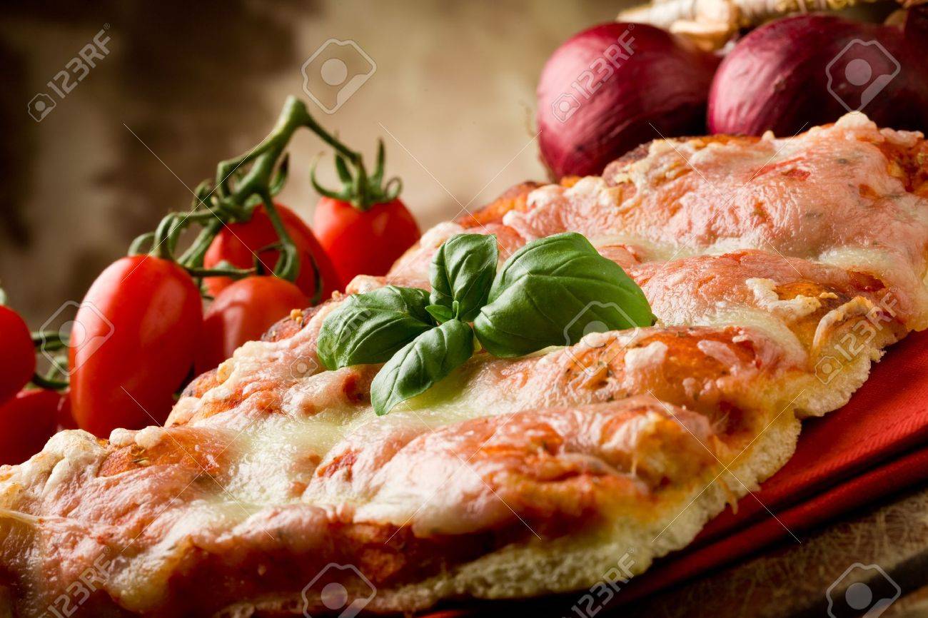 photo of delicious slice of pizza with basil leaf on it - 9456511 photo of delicious slice of pizza with basil leaf on it - 9456511