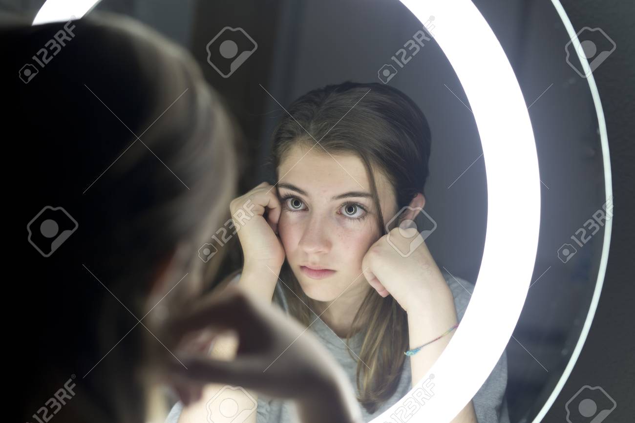 Portrait Of Teenage Looking In A Mirror, With The Sad And Serious Face.  Horizontal Shot. Stock Photo, Picture and Royalty Free Image. Image  69133584., image size:1300x866