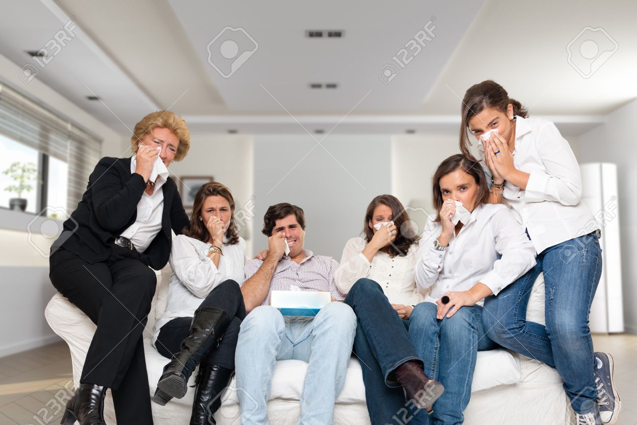 9603086-a-group-of-family-members-sitting-at-home-crying-watching-tv.jpg